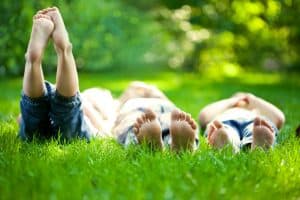 Selective focus three children in grass at picnic