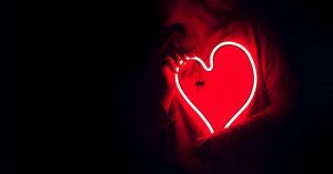 71380-person-holding-neon-heart-dark-designecologis.1200w.tn