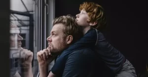 10325-man-son-window-covid-getty-westend6-12001