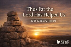 Stone memorial reminiscent of an Ebenezer at sunrise with the text ‘Thus Far the Lord Has Helped Us, A 2025 Ministry Report,’ symbolizing God’s faithfulness.