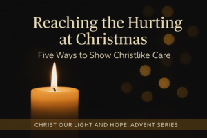 A single glowing candle sits against a deep charcoal background with soft golden bokeh lights in the distance. Centered above the flame is the title “Reaching the Hurting at Christmas” with the subtitle “Five Ways to Show Christlike Care.” A muted gold footer bar at the bottom reads “Christ Our Light and Hope: Advent Series.