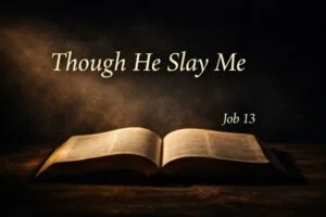 Open Bible resting in darkness with warm light illuminating the pages, symbolizing Job 13 and the call to trust God even when understanding fails, with the words “Though He Slay Me” displayed above.