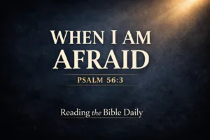 Dark navy textured background with soft golden light breaking in from the top corner and bold serif text reading ‘When I Am Afraid – Psalm 56:3’ with ‘Reading the Bible Daily’ below, representing trusting God in the midst of fear.