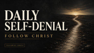 A narrow, weathered path leads through a dark charcoal landscape toward a warm-gold horizon and a subtle cross, with the text “Daily Self-Denial” and “Follow Christ.