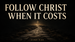 Stone path leading to a cross under the words “Follow Christ When It Costs,” with Luke 9:23.